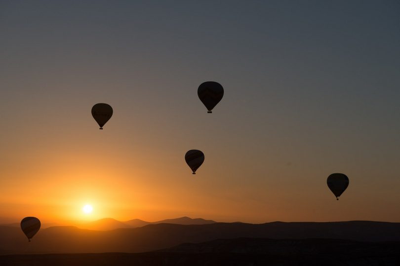 four hot air balloons that have drifted apart