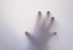hand against glass -- mental health and anxiety