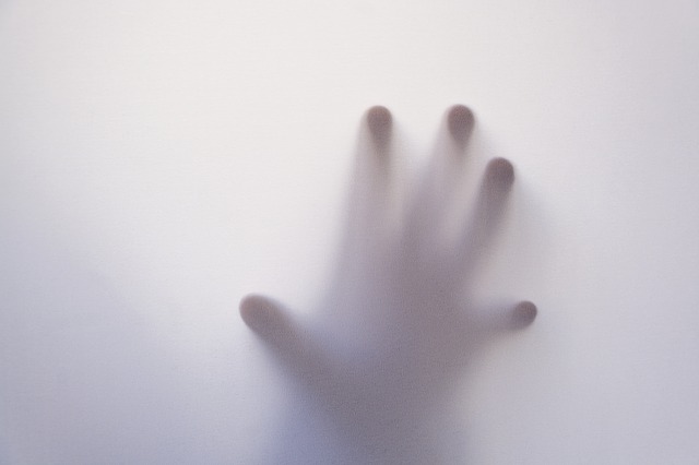 hand against glass -- mental health and anxiety