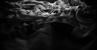 rumpled sheets in the bed where he fucks me