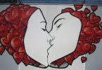 graffiti art sharing a kiss