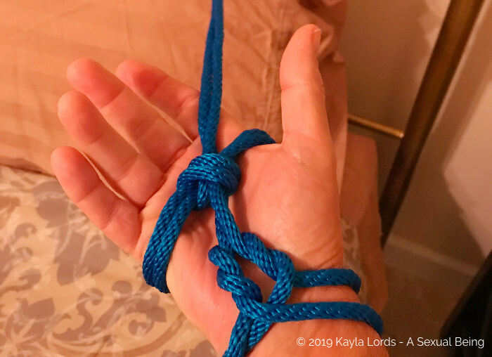 John Brownstone's hand in a practice rope bondage tie