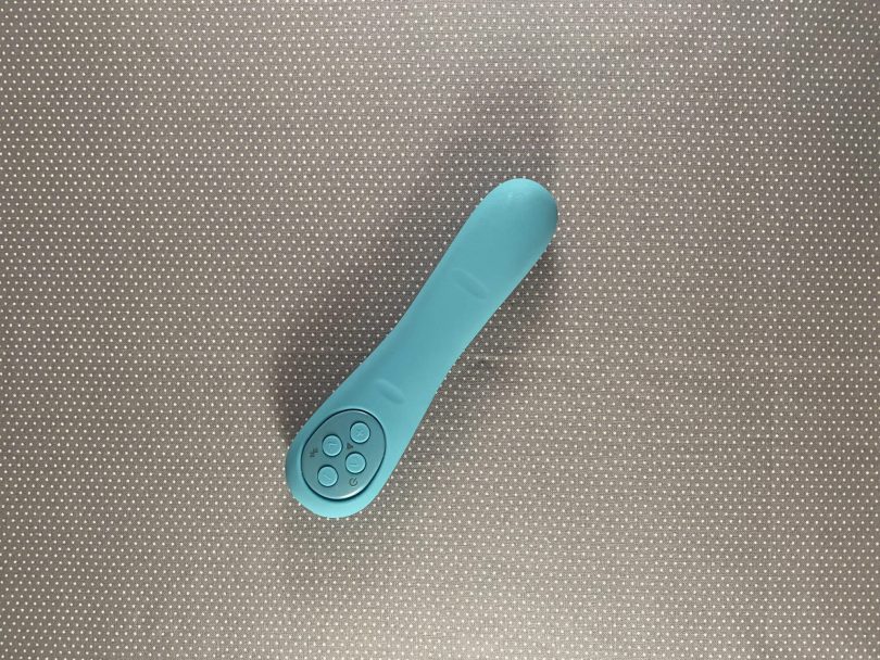 Poco by Mystery Vibe on gray background, turquoise vibrator shaped similarly to a finger
