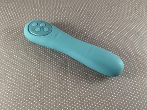 Poco vibrator from Mystery Vibe in teal color on gray fabric background