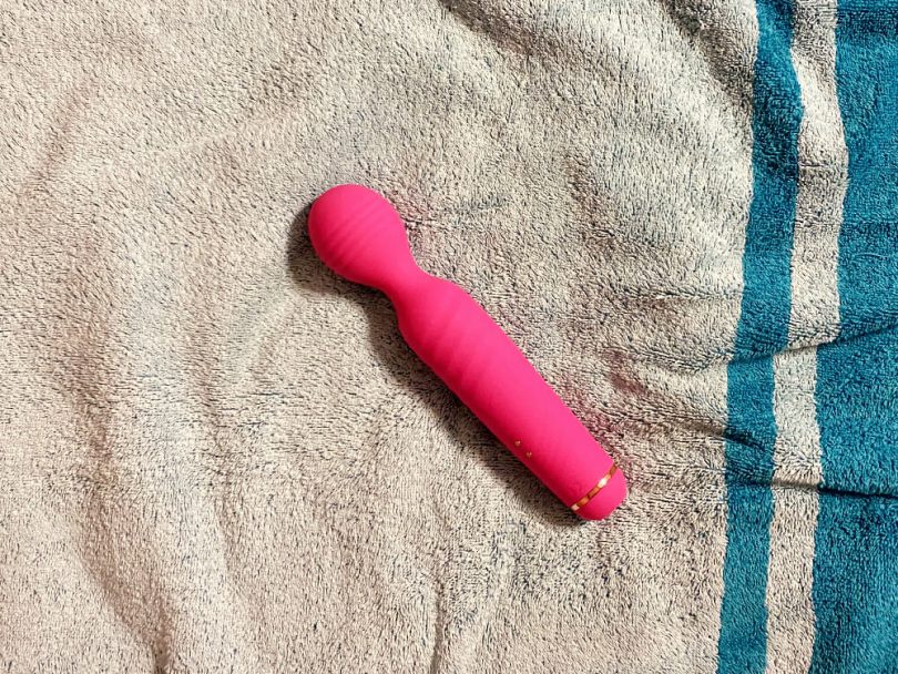 Sucking Clitoral Stimulator and Wand Massager by Sohimi on turquoise towel